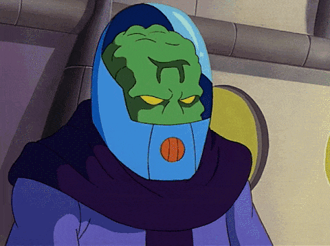 Floating aliens in robes, with glass helmets; inside the helmets their green faces can be seen, and the symbol for pi is stamped on each's forehead