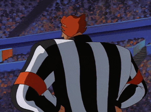 Referee Stanley turning to face the camera and smiling